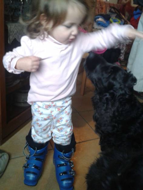 Our young friend trying on mummies boots whilst playing with Max